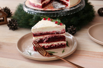 Piece of tasty Christmas cake on wooden table