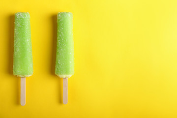 Delicious popsicles on color background