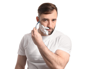 Handsome man shaving against white background