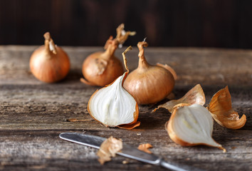 Fresh onions on rustic wooden background. Onions background. Ripe onions. 