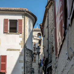 Fototapeta na wymiar narrow street with old fasades of buildings in historical center of san marino city