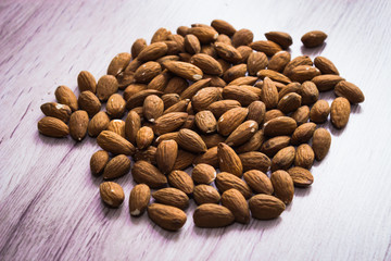 Almond. Almond on a wooden background macro. Almond background. Almond Nuts.