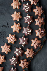 Star-shaped chocolates on dark wooden background
