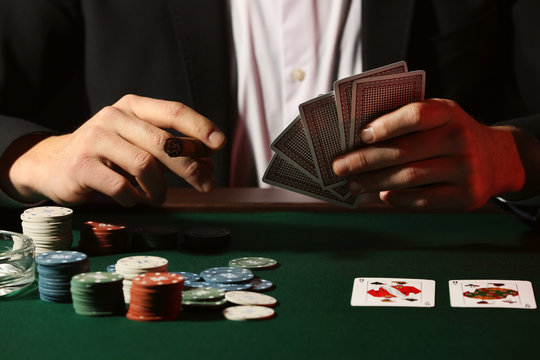 Male player at table in casino, closeup