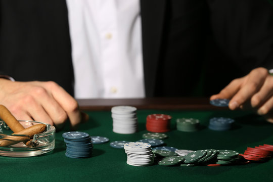 Male player at table in casino, closeup