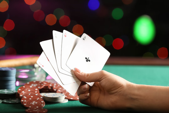 Woman playing cards in casino, closeup