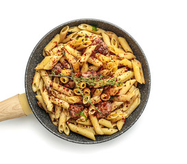 Tasty pasta with meat and spices in pan on white background