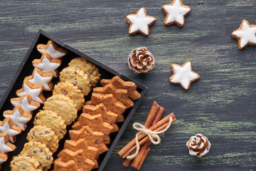 Christmas chocolate chip cookies, flat lay with spices and winter decorations on dark