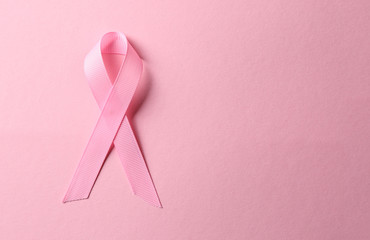 Pink ribbon on color background. Breast cancer awareness concept