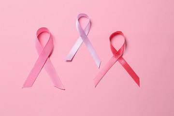 Pink ribbons on color background. Breast cancer awareness concept