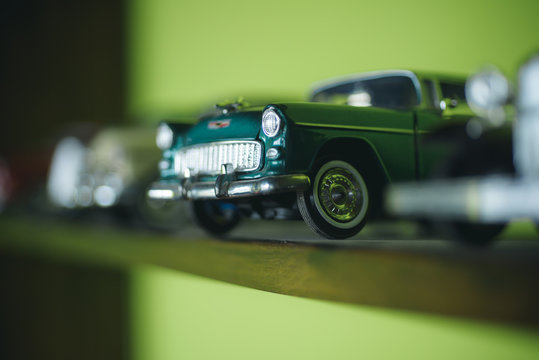 Fototapeta A close attention to the details. Retro styled cars. Toy cars with retro design. Retro car models on shelf. Classic model vehicles or toy vehicles. Miniature collection of automobiles