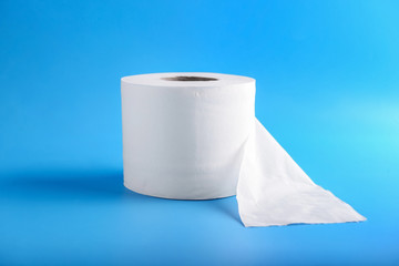 Roll of toilet paper on color background