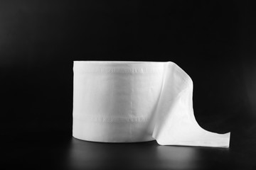 Roll of toilet paper on dark background