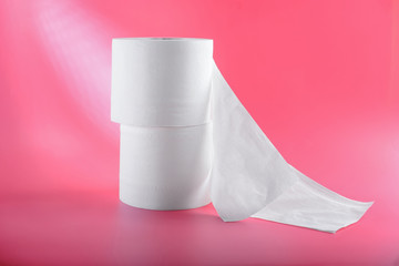 Rolls of toilet paper on color background