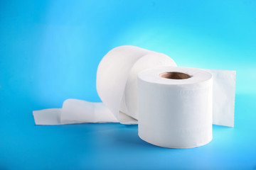 Rolls of toilet paper on color background