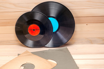 Vinyl record in front of a collection of albums, vintage process. Copy space for text