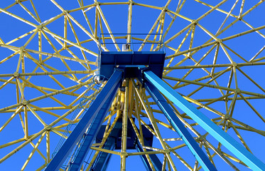iron beams and spokes of the ferris wheel in sunny weathe