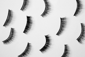 Many false eyelashes on white background