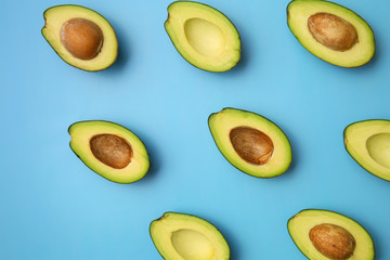 Plenty of fresh avocados on color background