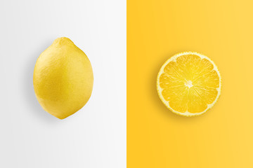 Creative background, lemon and lemon slices on a white and yellow background. Flat lay, copy space. The concept of nutrition, fresh fruit, natural products, juice.