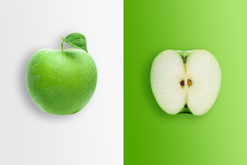Creative background, green apple and slices of apple on a white and green background. Flat lay, copy space, layout. The concept of nutrition, fresh fruit, natural products, juice.