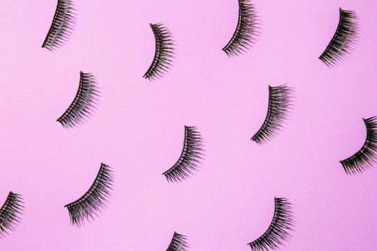 Many false eyelashes on color background