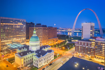 St. Louis, Missouri, USA downtown cityscape with the arch and courthouse at dusk.