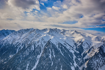 Scenic alpine landscape with and mountain ranges. forest and snow-capped mountain tops in the background. National park of Kyrgyzstan. Nice view.
