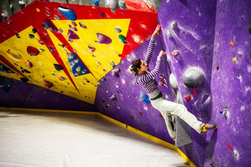 Woman climbing indoor