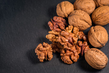 Walnuts on dark slate background. Concept of the healthy food.
