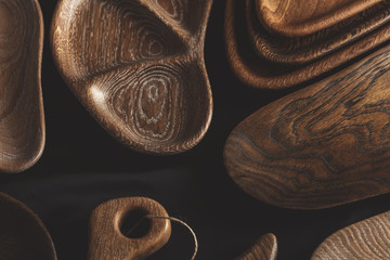 Set of wooden DIY plates, dishes, bowls and trays of different wooden texture, closeup, top view.