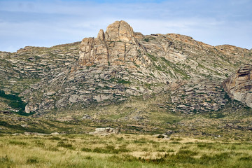 Beautiful panoramic summer steppe landscape of stone mountains 