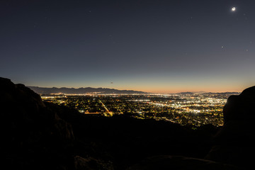 Predawn view of sprawling west San Fernando Valley neighborhoods from rocky peaks in the Santa Susana Mountains above Los Angeles, California.