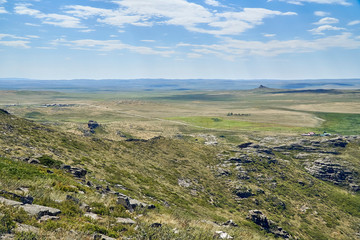 Naklejka premium Beautiful panoramic summer steppe landscape of stone mountains 