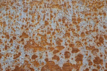 Surface of the underwater part of the hull of a ship with paint residues and rust stains