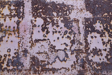 Red painted metal surface with large rust stains as background