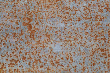 Surface of the underwater part of the hull of a ship with paint residues and rust stains