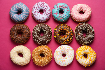 Sweet tasty donuts on color background