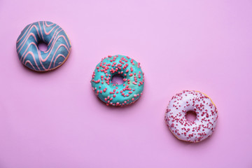 Sweet tasty donuts on color background