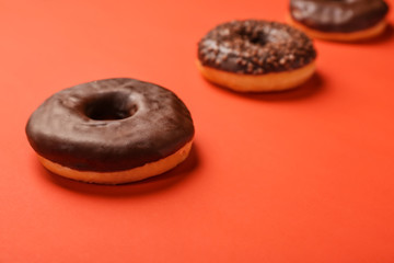 Sweet tasty donuts on color background