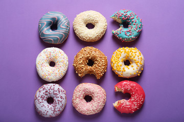 Sweet tasty donuts on color background