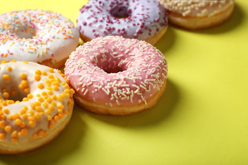 Sweet tasty donuts on color background