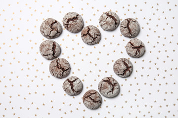 Heart shape made from tasty chocolate cookies on light background
