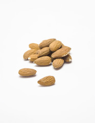 almond pile on white background selective focus