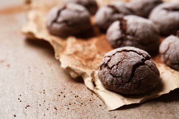 Tasty chocolate cookies on parchment, closeup