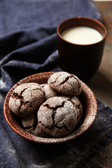 Tasty chocolate cookies with milk on table