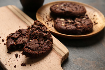 Tasty chocolate cookie on wooden board