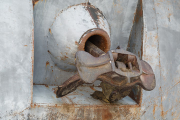 Rusty anchor is in a regular place on the hull of a river ship