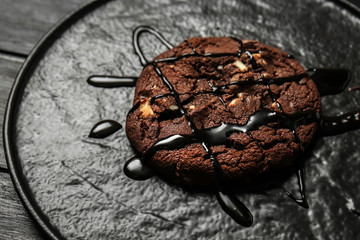 Tasty chocolate cookie on plate, closeup
