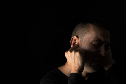 suffering man with his hands in his head